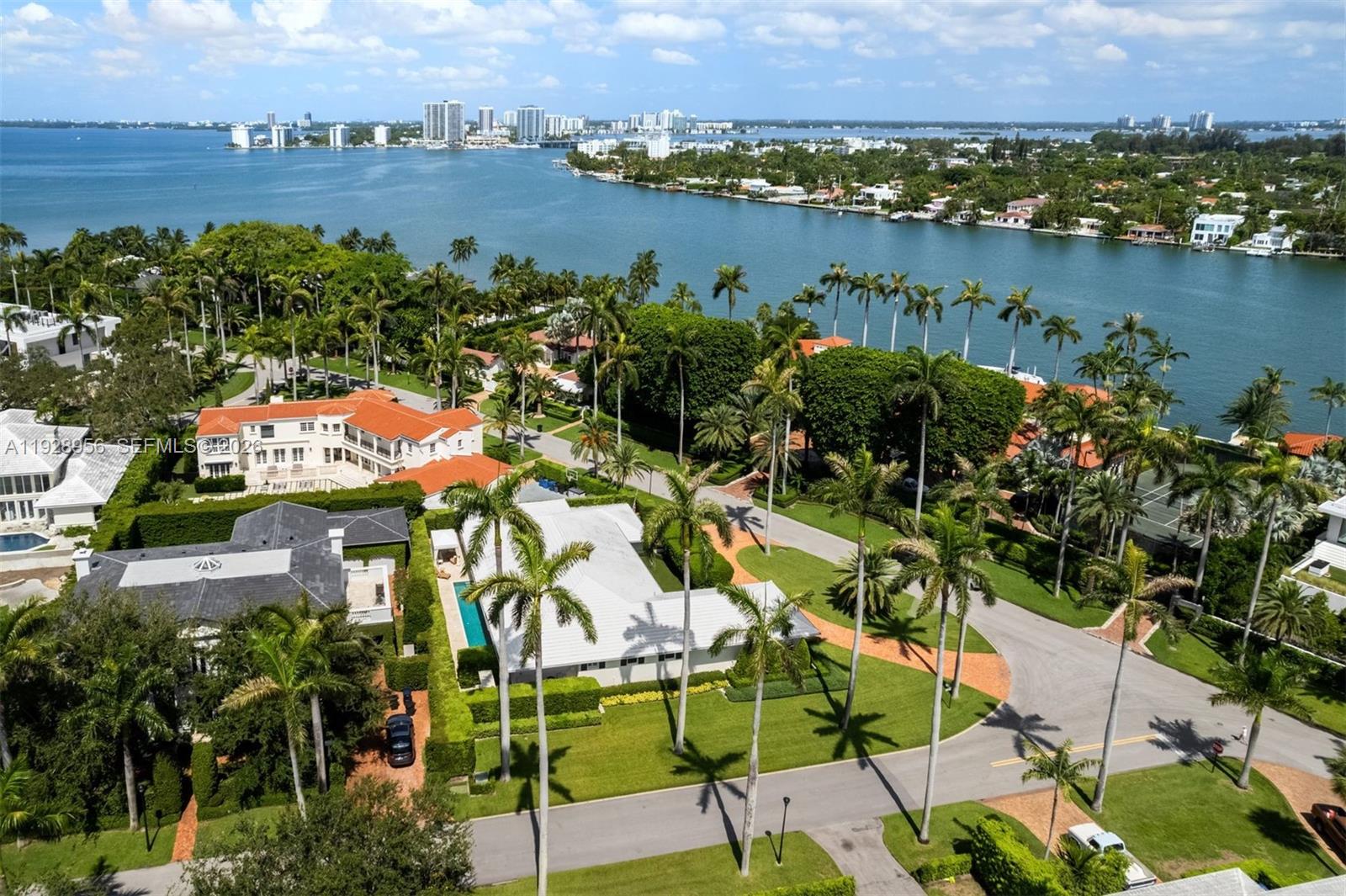 An aerial view shows luxury waterfront homes surrounded by palm trees and manicured lawns — 55 La Gorce Cir, Miami Beach FL 33141, MIAMI BEACH, FL
