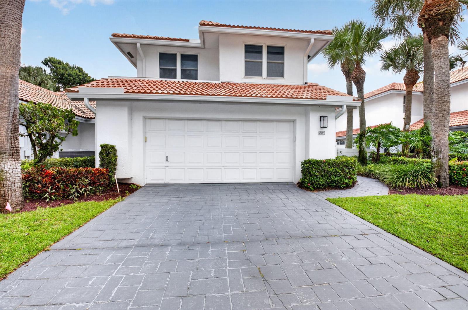 A two-story white house with a tiled roof and a paved driveway — 2103 NW 53rd Street, Boca Raton FL 33496, BOCA RATON, FL