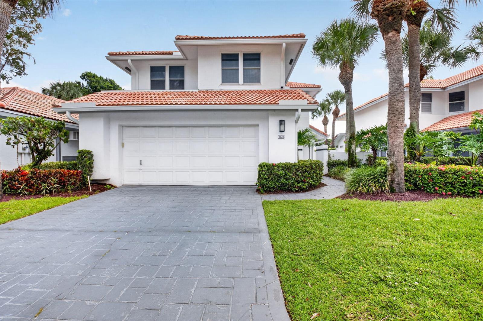 A two-story white house with a tiled roof, a garage, and a paved driveway — 2103 NW 53rd Street, Boca Raton FL 33496, BOCA RATON, FL