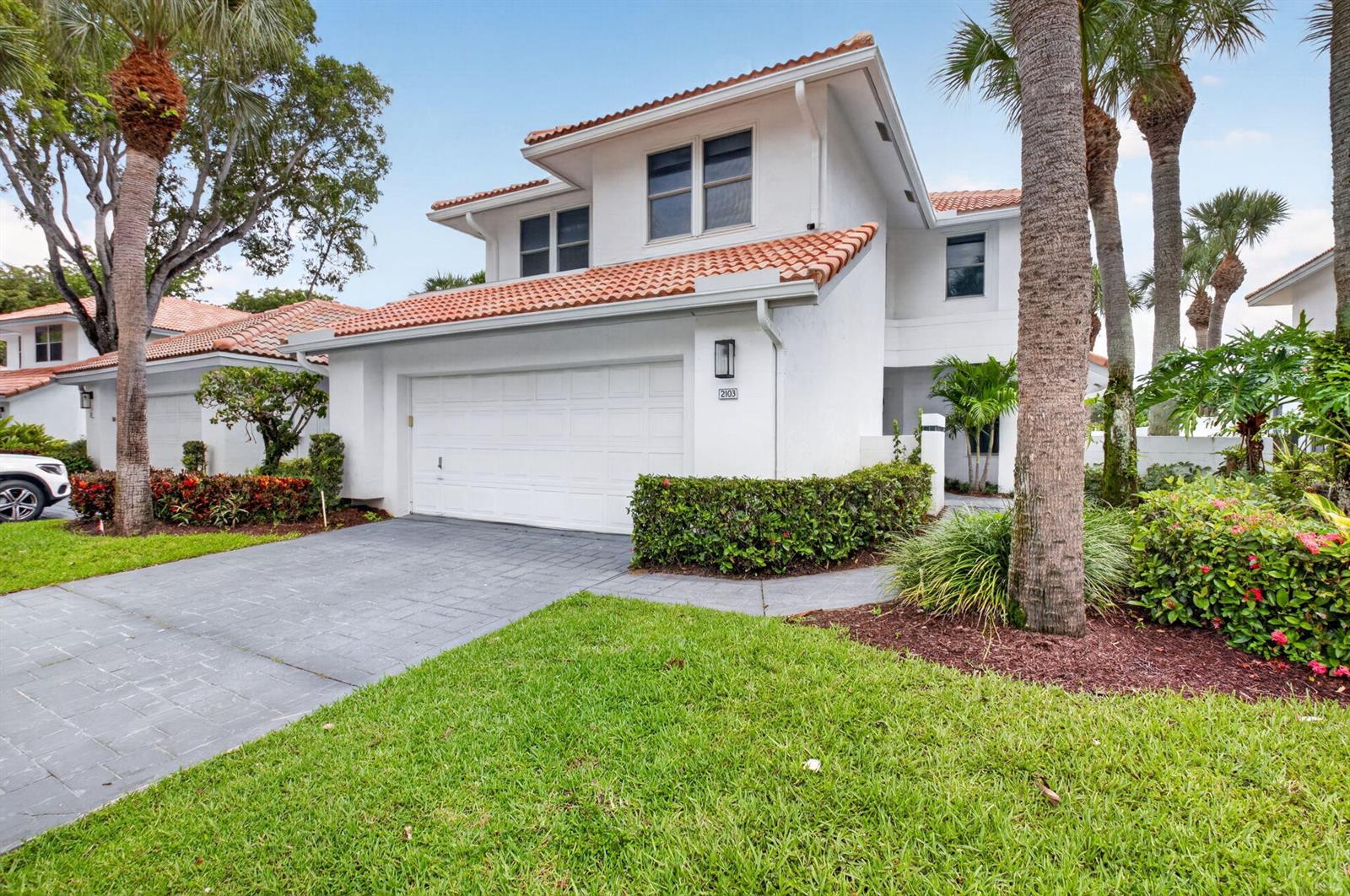 A two-story white house with a tile roof, a garage, and palm trees — 2103 NW 53rd Street, Boca Raton FL 33496, BOCA RATON, FL