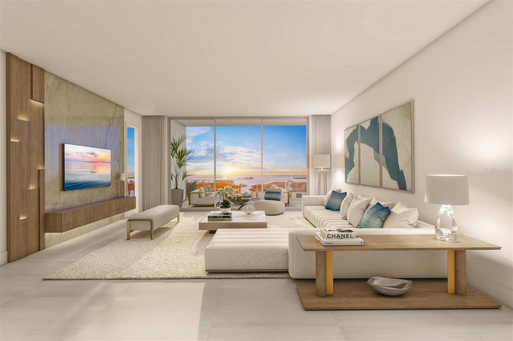 A living room features a white sofa, a marble coffee table, and coastal-themed wall art — 5713 BOWEN DANIEL DRIVE UNIT 604, TAMPA, FL