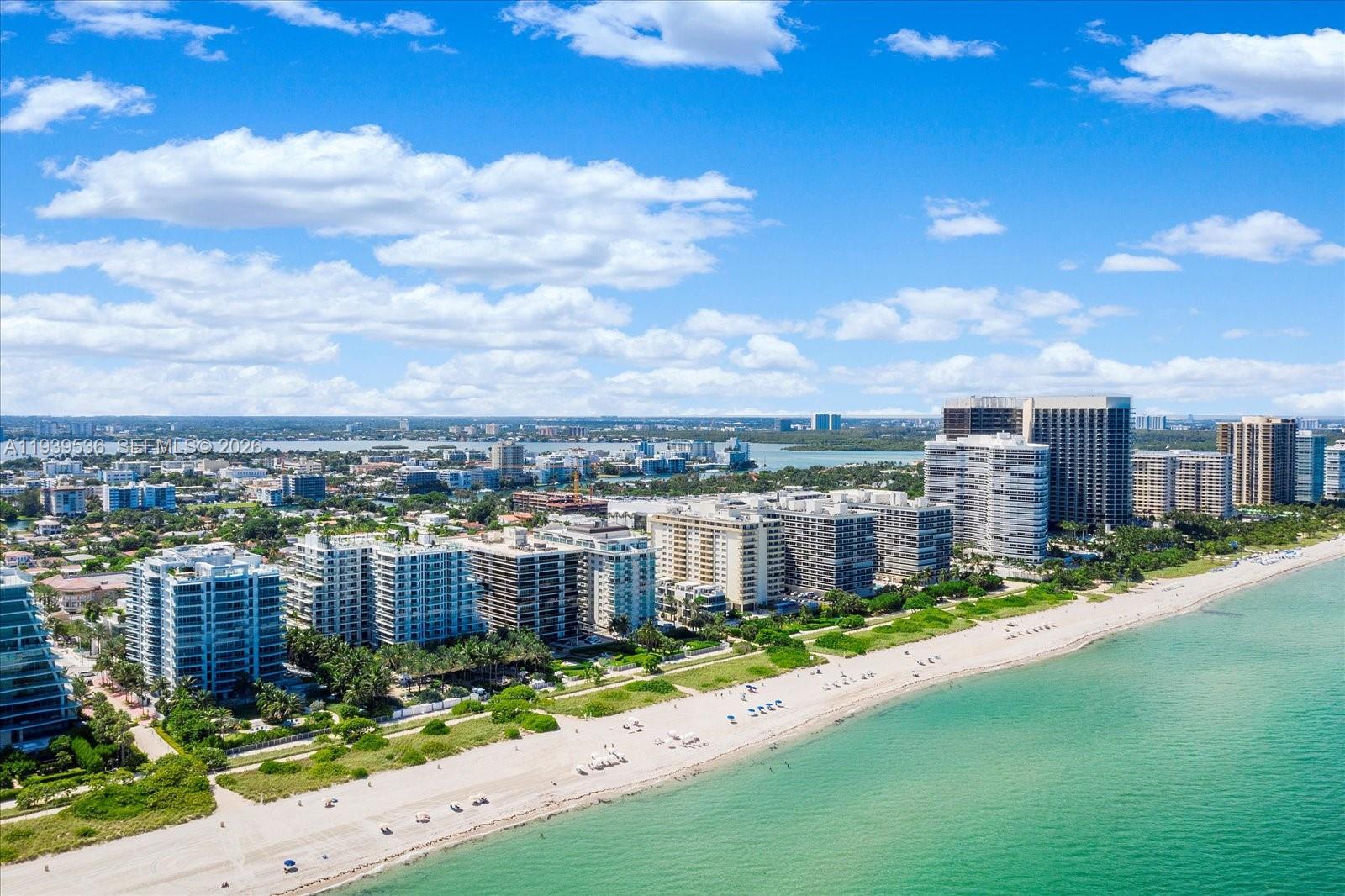 An aerial view of a sandy beach lined with high-rise residential buildings and palm trees — 9424 - 9432 Carlyle Ave, Surfside FL 33154, SURFSIDE, FL