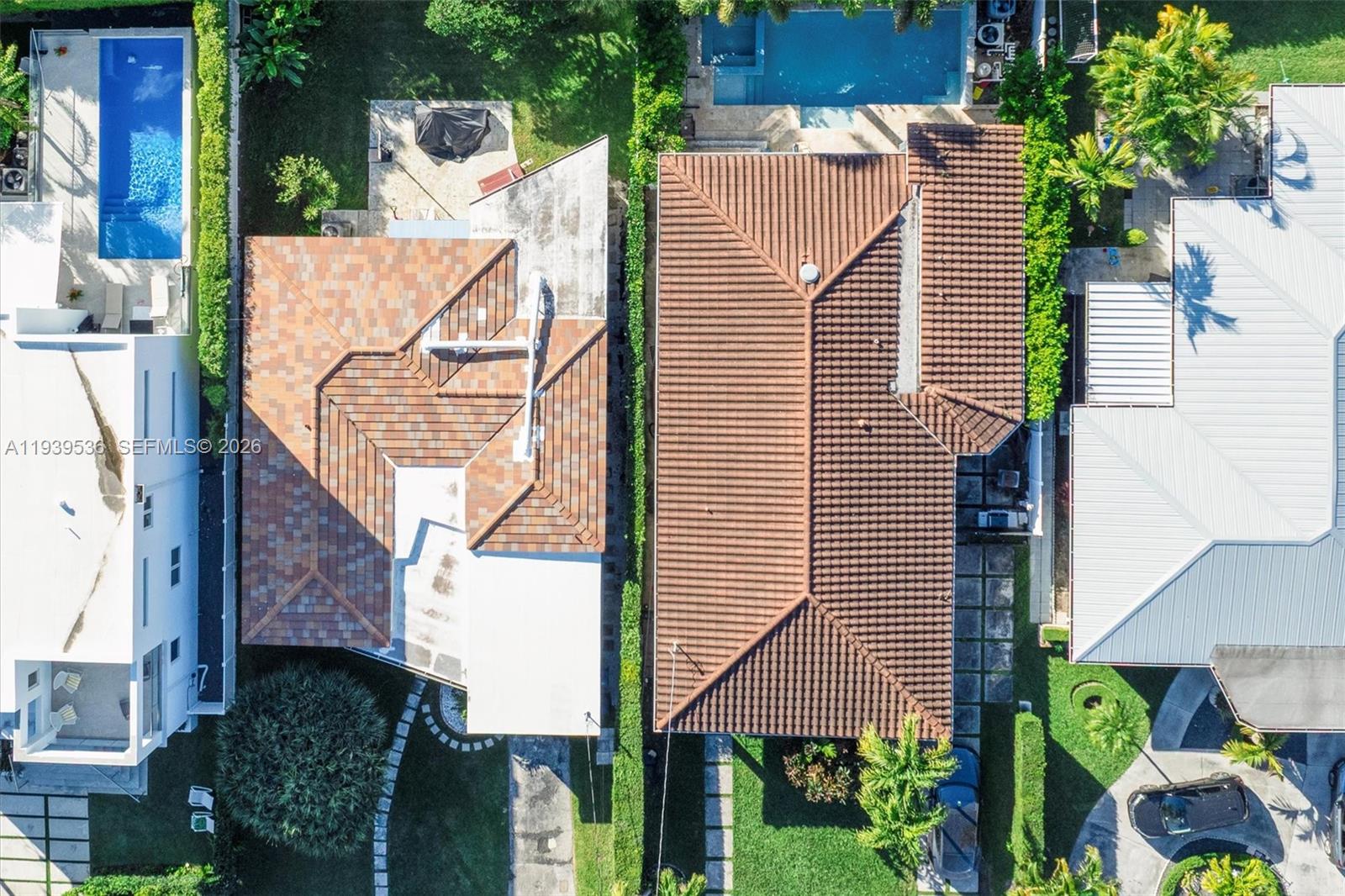 An aerial view shows two adjacent houses with tiled roofs, swimming pools, and landscaped yards — 9424 - 9432 Carlyle Ave, Surfside FL 33154, SURFSIDE, FL