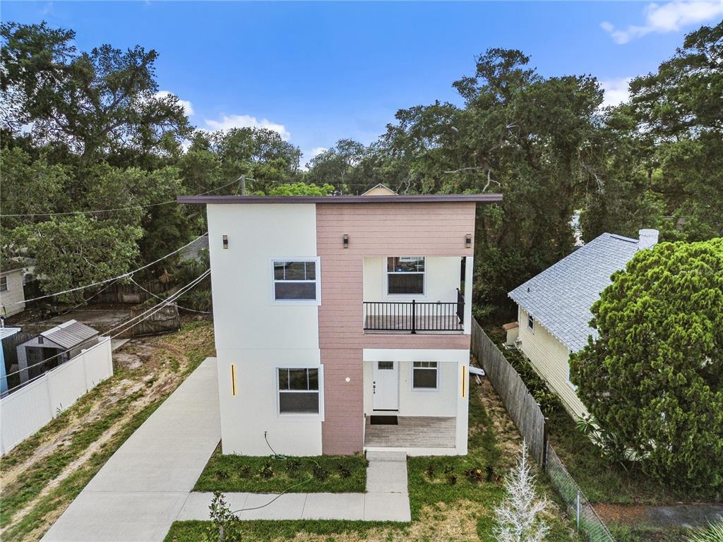 A two-story modern house features a flat roof, a balcony, and a split-tone exterior — 2141 UPTON COURT S, ST PETERSBURG, FL