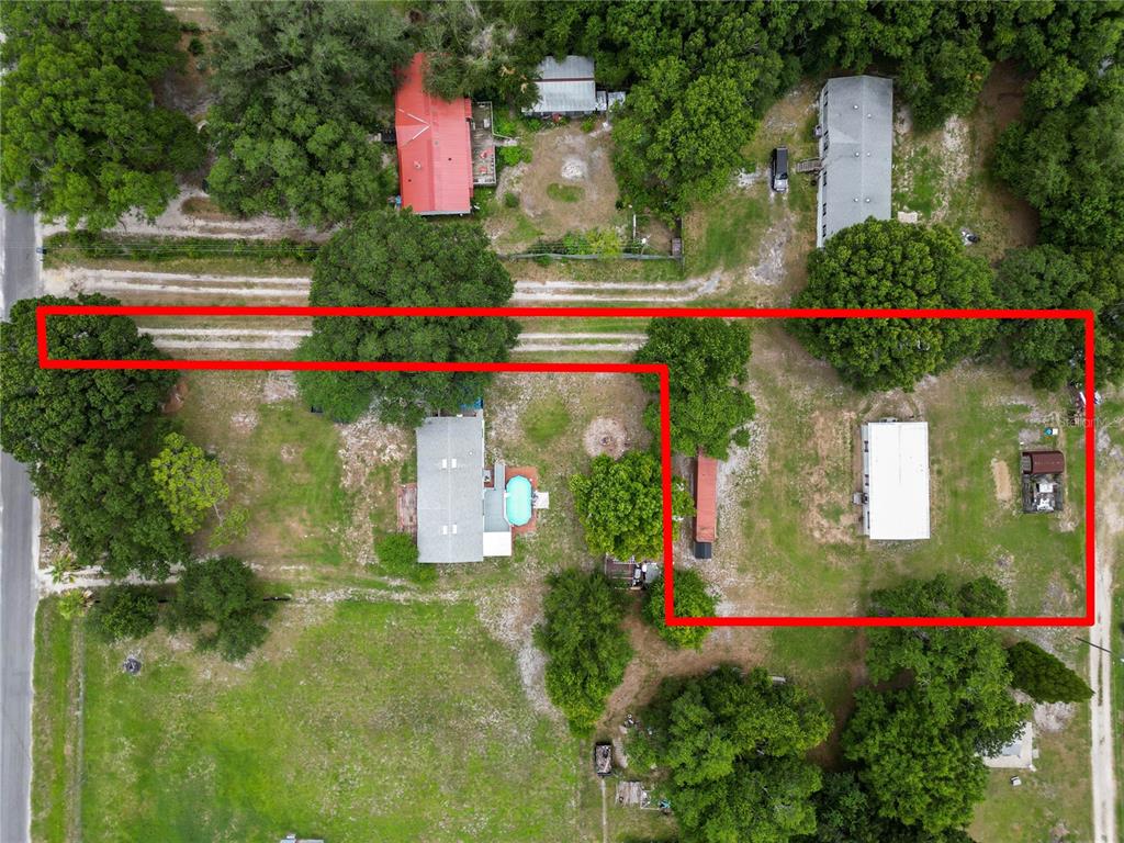 An aerial view shows a residential property with two houses and a pool outlined in red — 6216 DOVECREST TRAIL, LAKELAND, FL