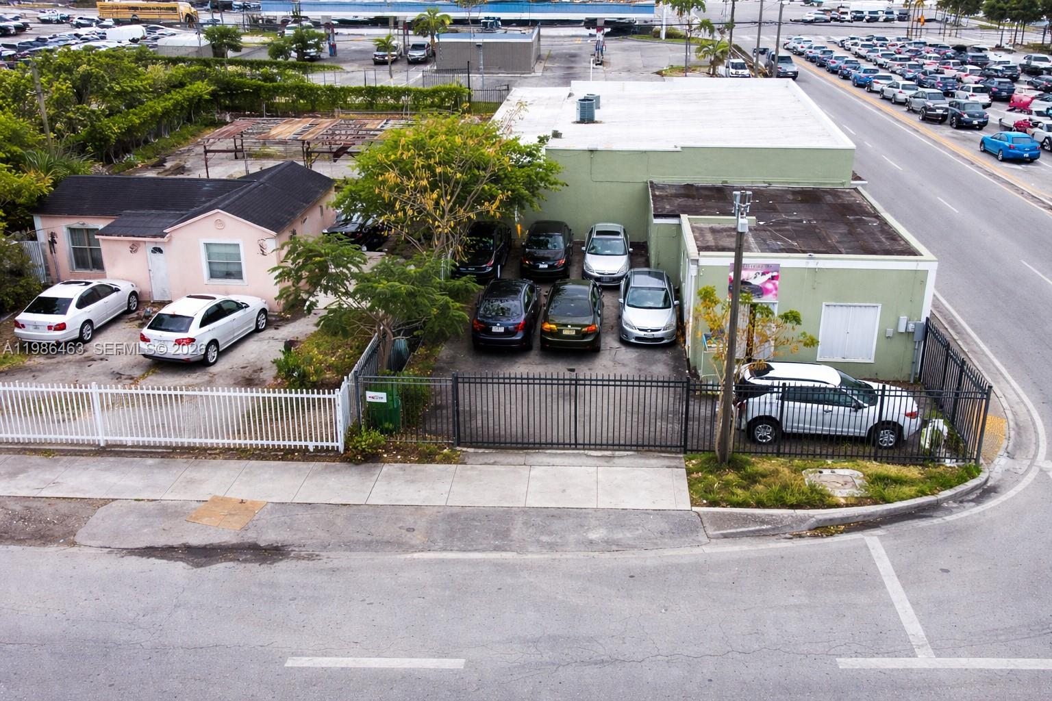 An aerial view shows a commercial property outlined in white along a busy road — 2618 NW 103rd St, Miami FL 33147, MIAMI, FL
