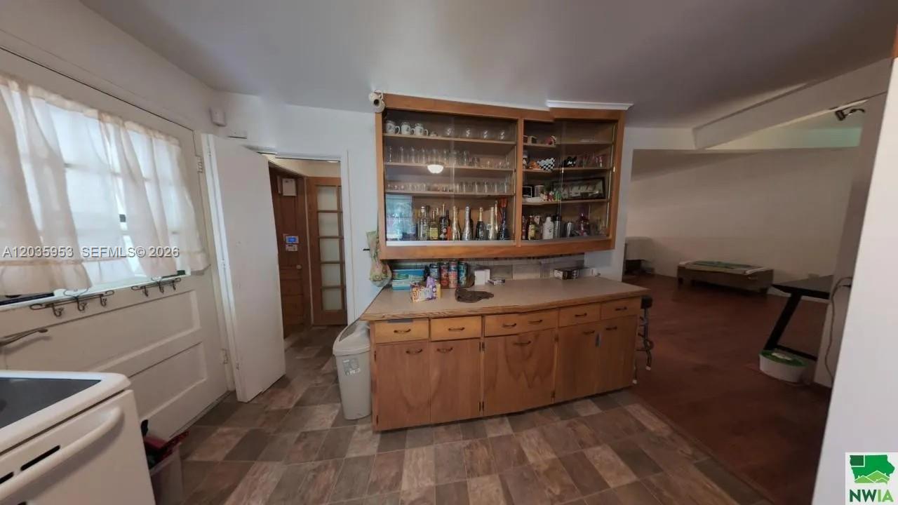 A kitchen features wood cabinets, a laminate countertop, and a built-in glass-front display hutch — 35 Hinshaw St, IA 51331, IA