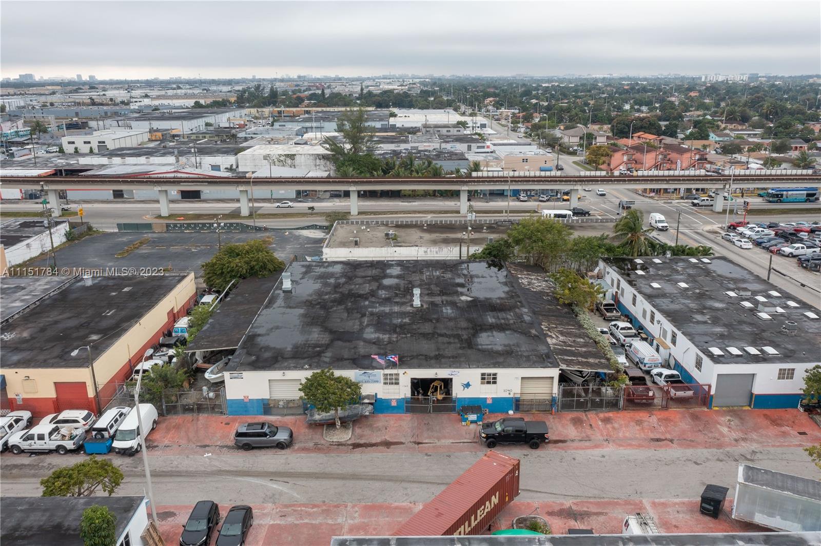 An aerial view shows a commercial building with a flat roof and adjacent parking lots — 1040 E 26th Street, Hialeah FL 33013, HIALEAH, FL