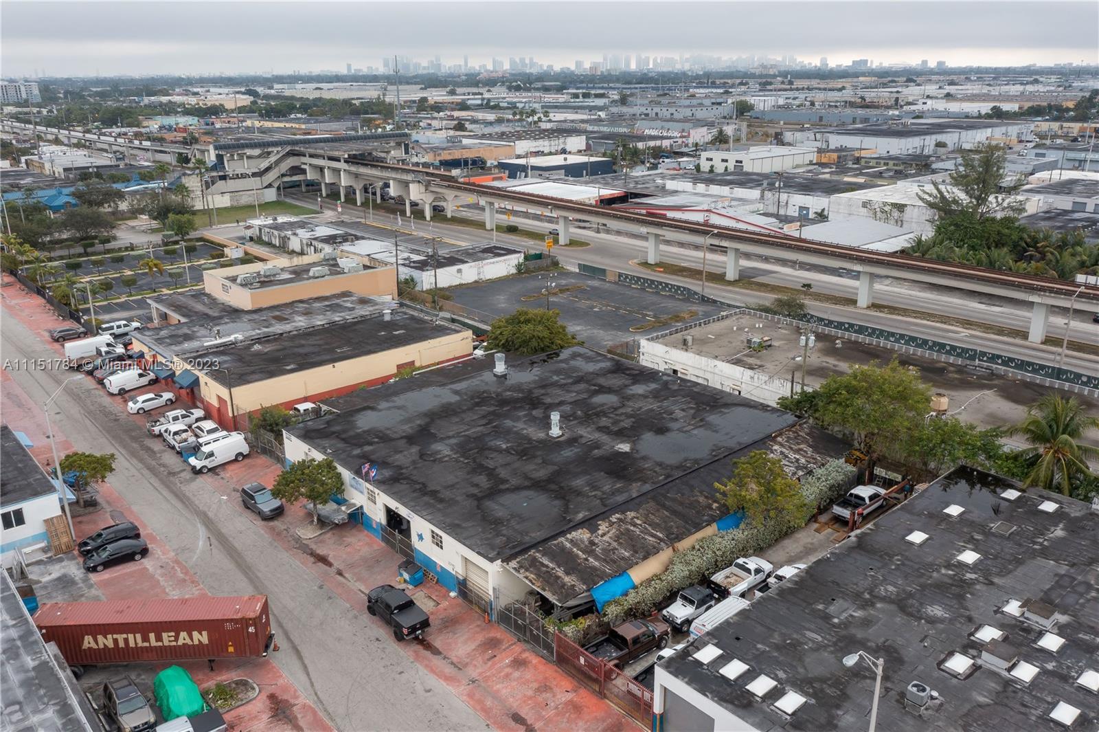 An aerial view shows commercial buildings, a parking lot, and an elevated train track nearby — 1040 E 26th Street, Hialeah FL 33013, HIALEAH, FL