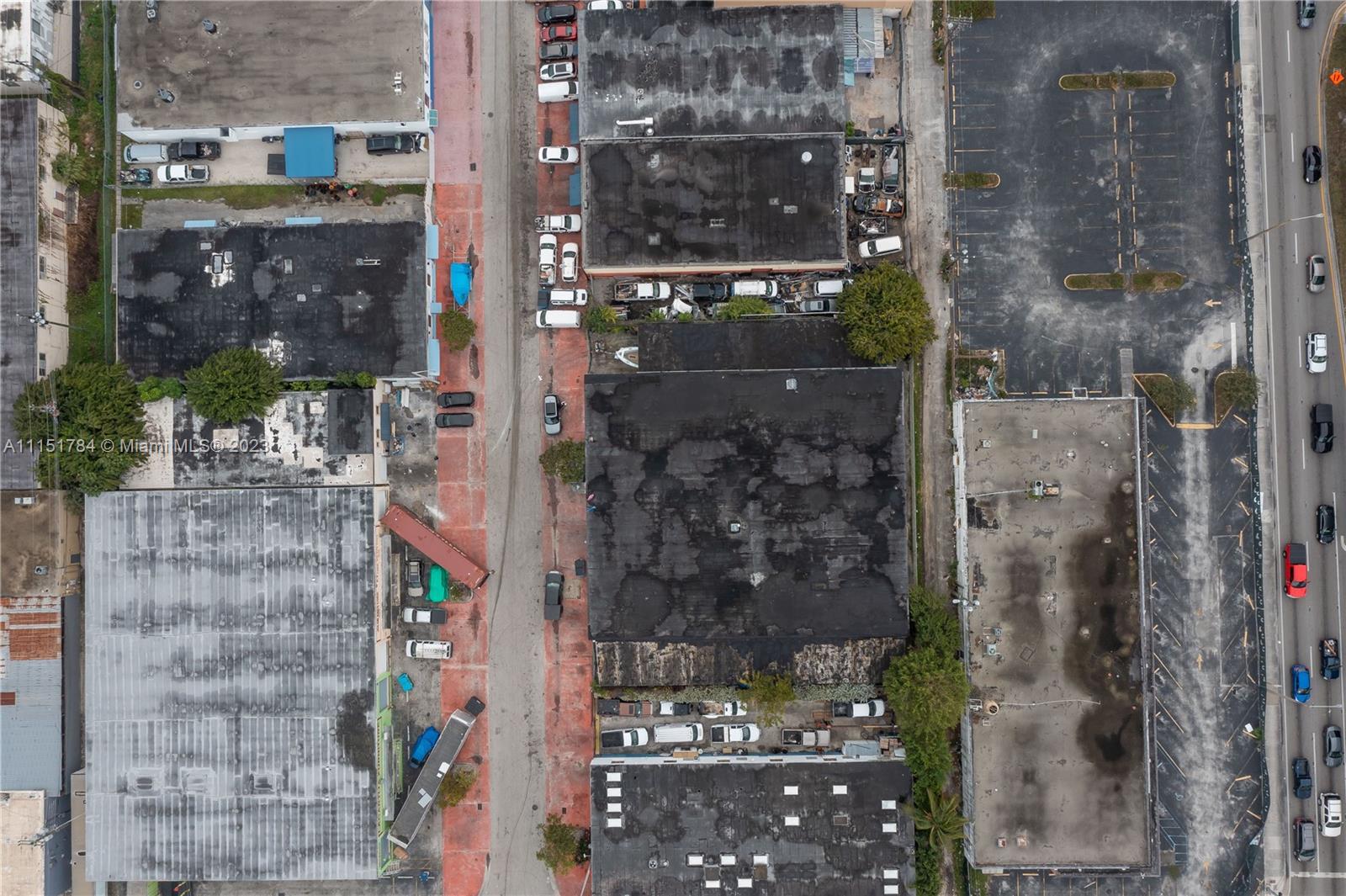 Aerial view of industrial buildings, parking lots, and a street with parked vehicles — 1040 E 26th Street, Hialeah FL 33013, HIALEAH, FL