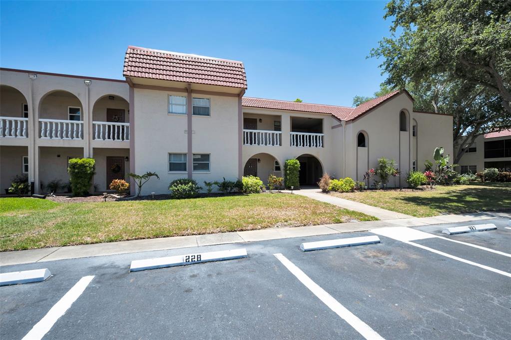 A two-story apartment building with a parking lot in the foreground — 9700 STARKEY ROAD UNIT 228, SEMINOLE, FL