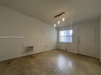 An empty room features white walls, a window with security bars, and a terrazzo floor — 142 SW 18th Ave # 20, Miami FL 33135, MIAMI, FL