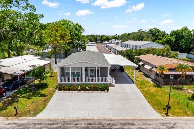 An aerial view shows a manufactured home with a white porch and attached carport — 8903 SHELDON WEST DRIVE, TAMPA, FL