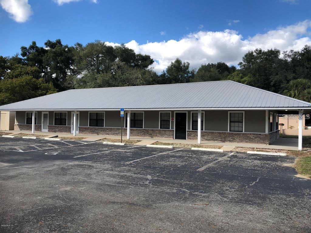 A single-story commercial building with a metal roof and a paved parking lot — 1100 SE 58TH AVENUE UNIT A, OCALA, FL