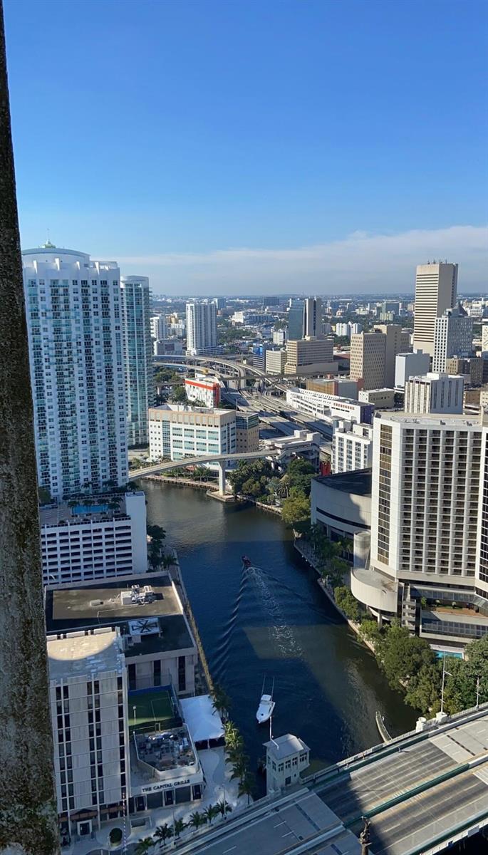 An elevated view of the Miami River, surrounding skyscrapers, and highway overpasses under a clear sky — 475 Brickell Avenue # 4615, Miami FL 33131, MIAMI, FL