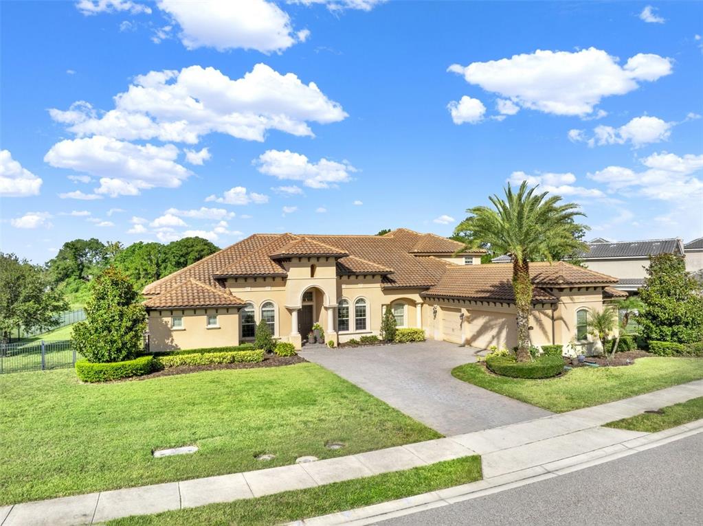 A single-story stucco house with a tile roof and a palm tree in the front yard — 3764 FARM BELL PLACE, LAKE MARY, FL