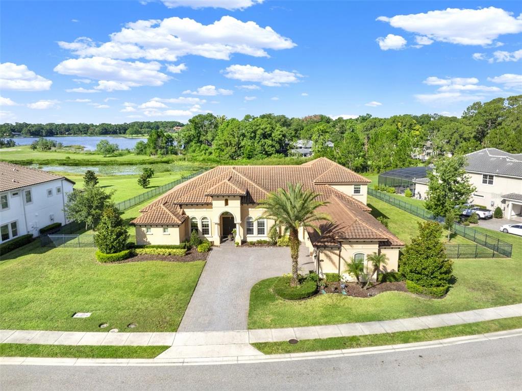 An aerial view of a tan, single-story house with a tiled roof and a driveway — 3764 FARM BELL PLACE, LAKE MARY, FL