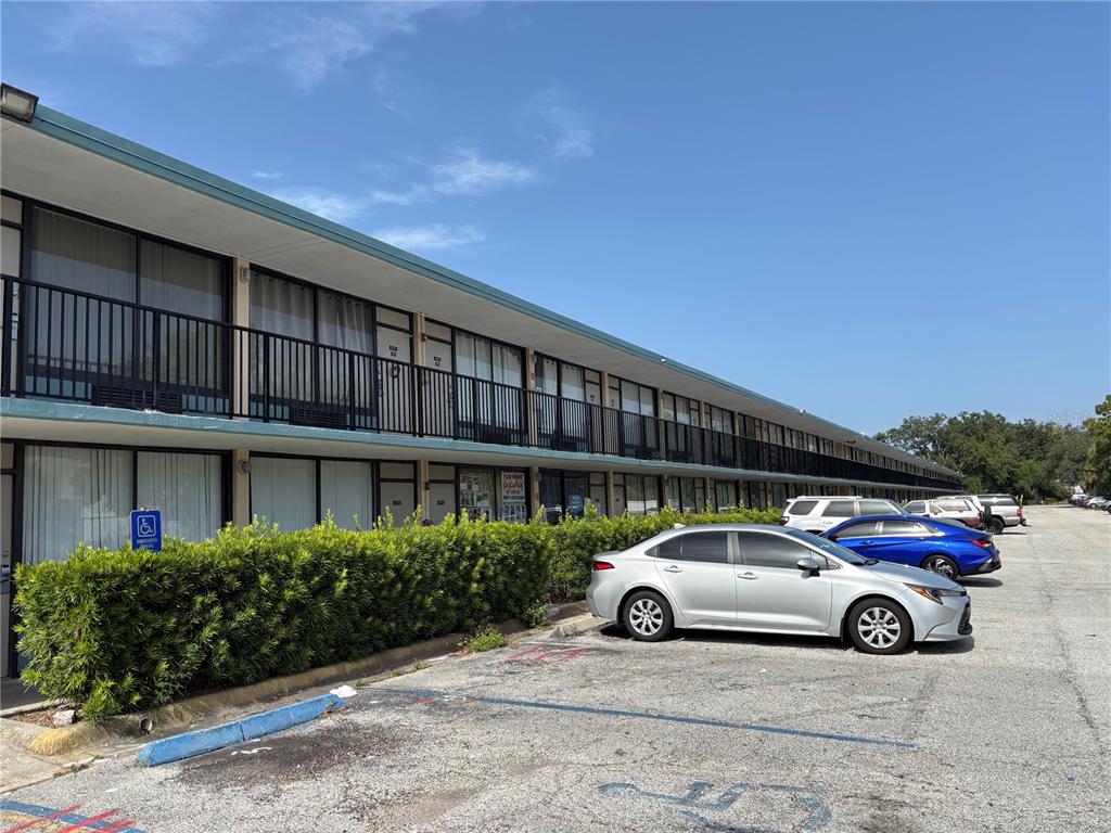 A two-story motel building with exterior walkways and a parking lot in front — 7900 S ORANGE BLOSSOM TRAIL UNIT 2009, ORLANDO, FL