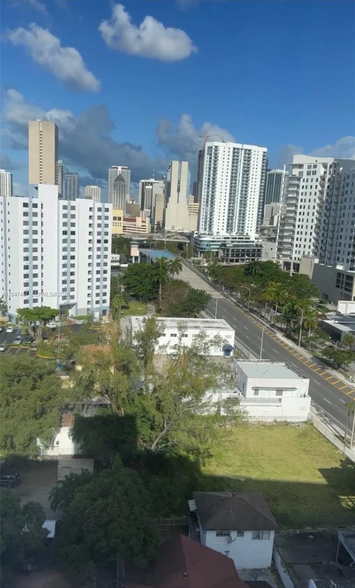 An elevated view of a city skyline featuring high-rise buildings, a road, and surrounding trees — 36 NW 6th Ave # 1, Miami FL 33128, MIAMI, FL