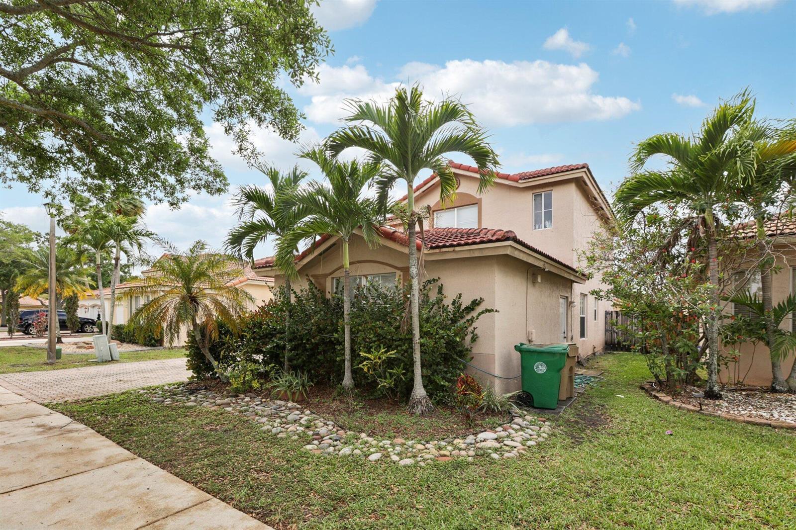 A two-story stucco house with a red tile roof and palm trees in the yard — 405 E Royal Cove Circle, Davie FL 33325, DAVIE, FL