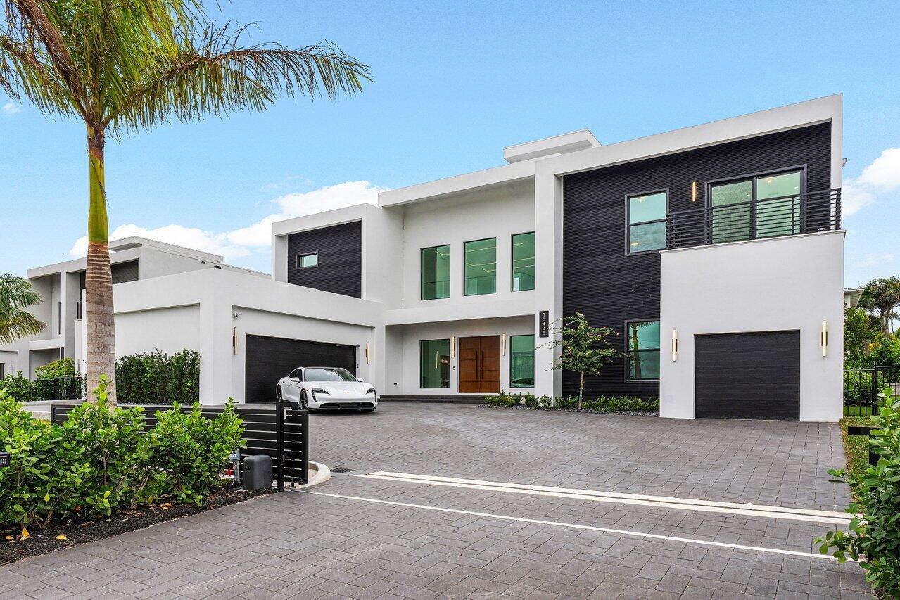 A modern two-story house with white and black exterior walls, a driveway, and a car — 13440 Us Highway 1, Juno Beach FL 33408, JUNO BEACH, FL