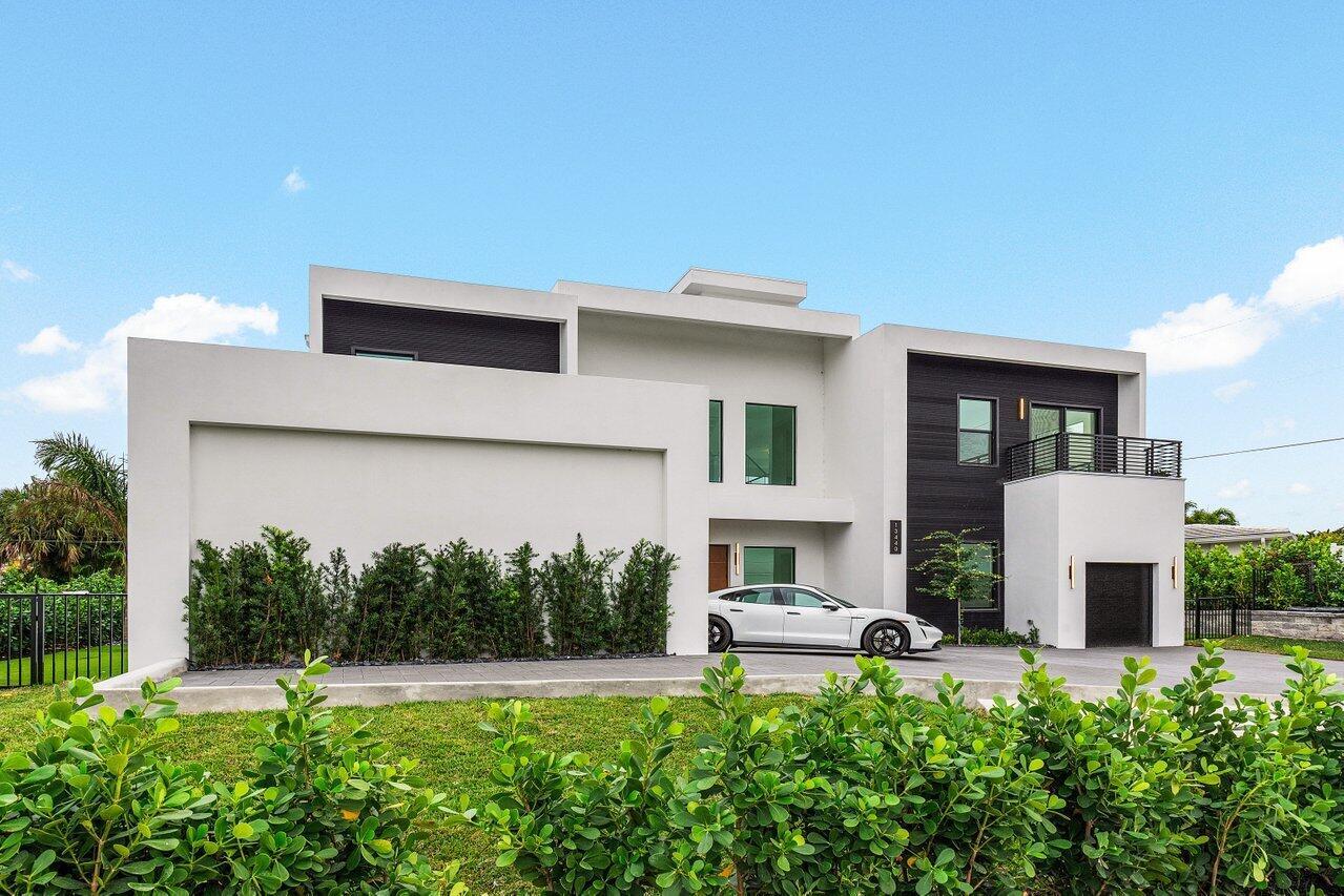 A modern two-story house with white and dark wood siding and a white sedan parked outside — 13440 Us Highway 1, Juno Beach FL 33408, JUNO BEACH, FL