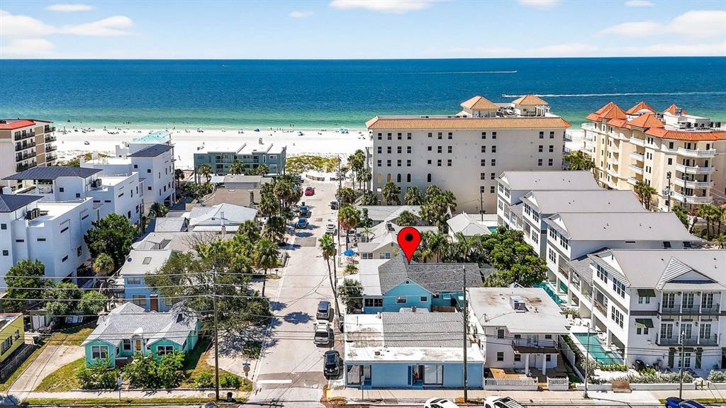 An aerial view shows a light blue house with a red location pin near the beach — 26 CAMBRIA STREET, CLEARWATER BEACH, FL