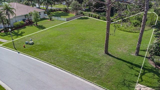 An aerial view shows a vacant, grassy residential lot outlined in white on a suburban street — 0 N POINTE ALEXIS DRIVE, TARPON SPRINGS, FL