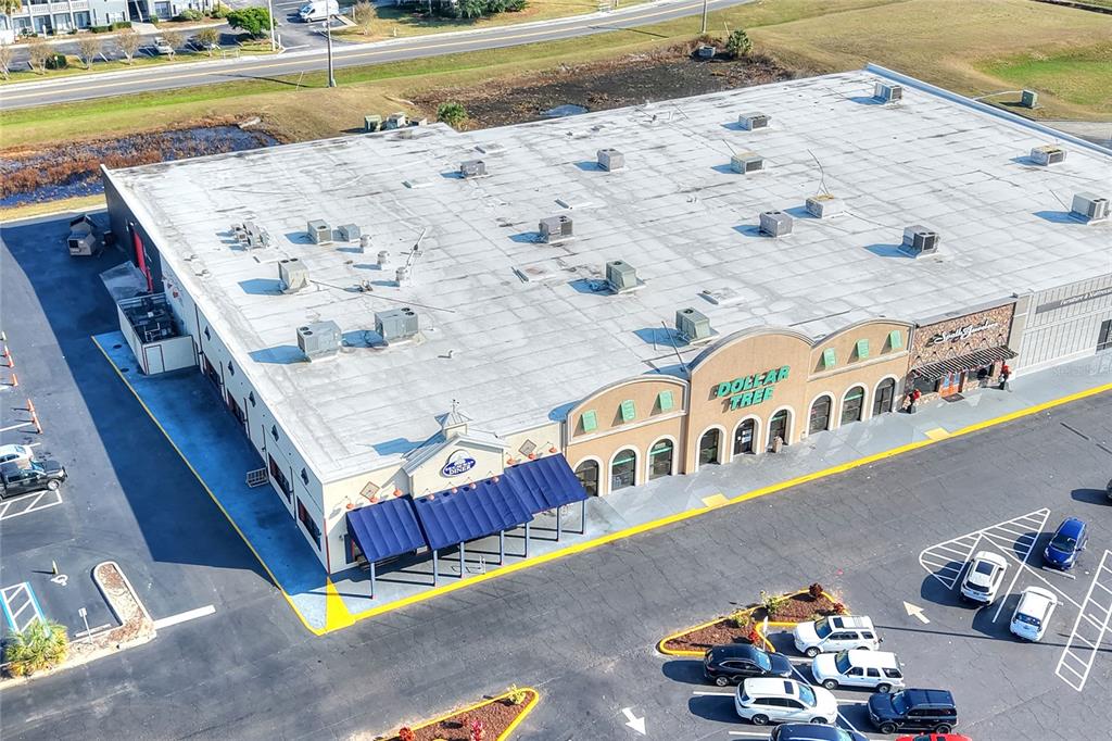 An aerial view shows a commercial building with a Dollar Tree store and parking lot — 1370 N BROADWAY AVENUE, BARTOW, FL