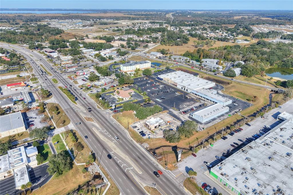Aerial view of a commercial area with a multi-lane road, parking lots, and buildings — 1370 N BROADWAY AVENUE, BARTOW, FL