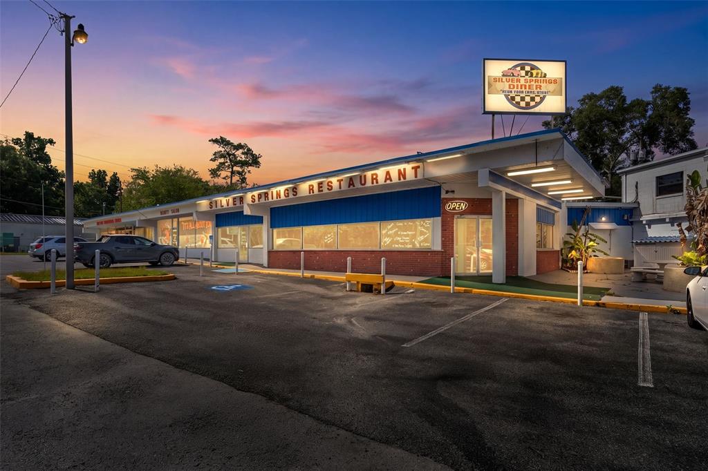 The exterior of a Silver Springs restaurant building features a parking lot at sunset — 5300 E SILVER SPRINGS BOULEVARD UNIT B, SILVER SPRINGS, FL