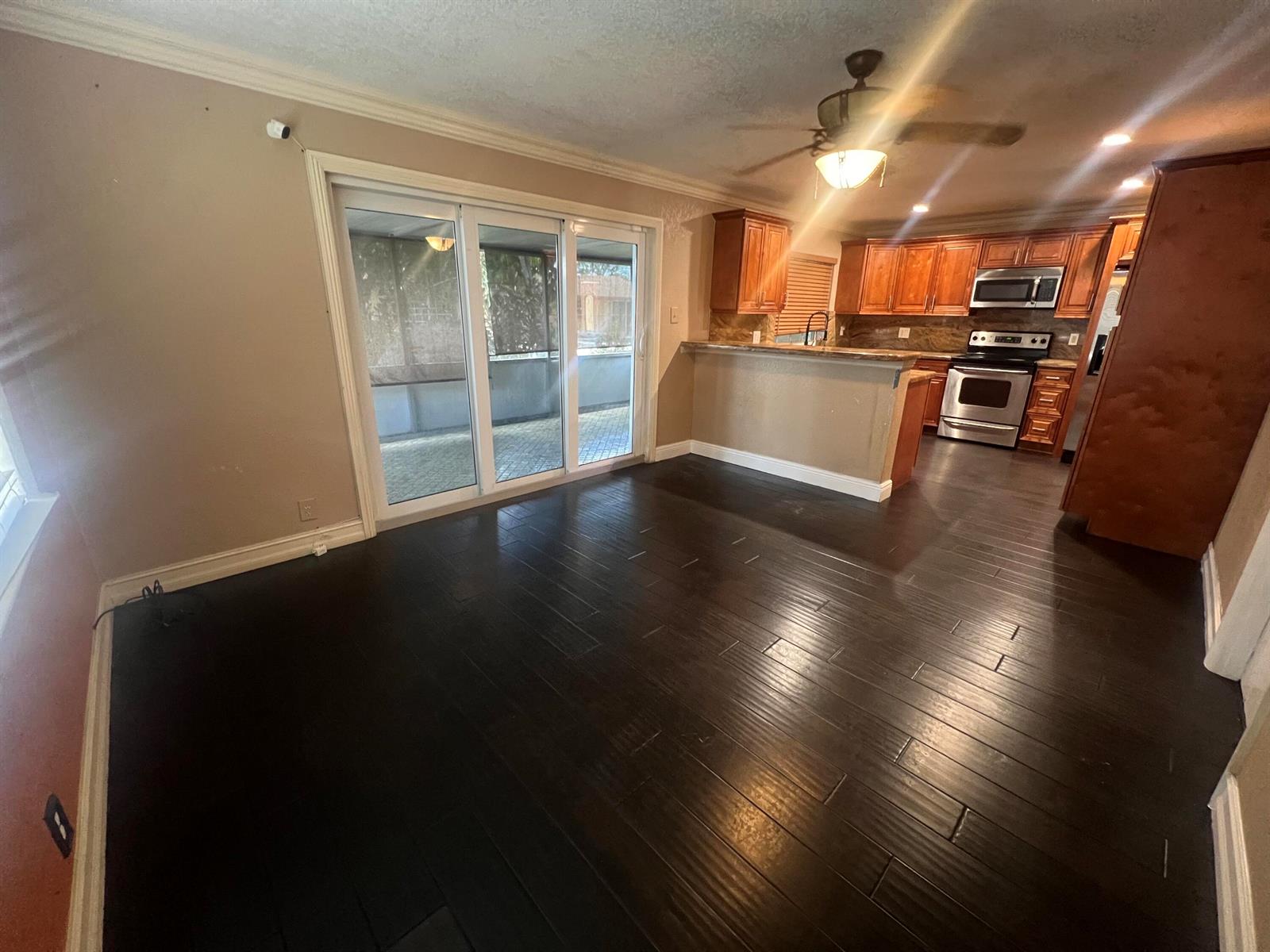 A bathroom features a walk-in shower, a toilet, and a vanity with a beige countertop — 511 SW 63rd Terrace, Margate FL 33068, MARGATE, FL