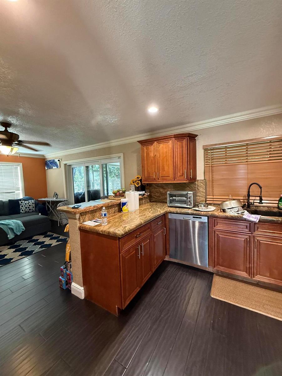 A bathroom features a vessel sink, a tall white cabinet, and a blue seashell shower curtain — 511 SW 63rd Terrace, Margate FL 33068, MARGATE, FL