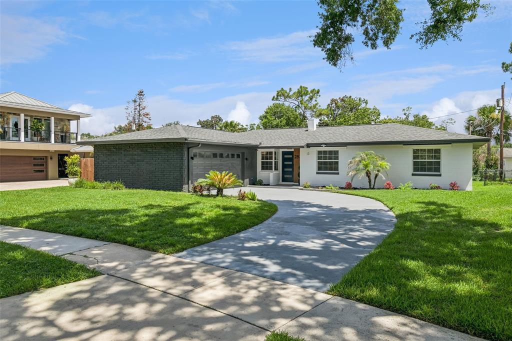 A single-story house with a white and dark gray brick exterior and a curved driveway — 2833 PRINCE JOHN ROAD, WINTER PARK, FL