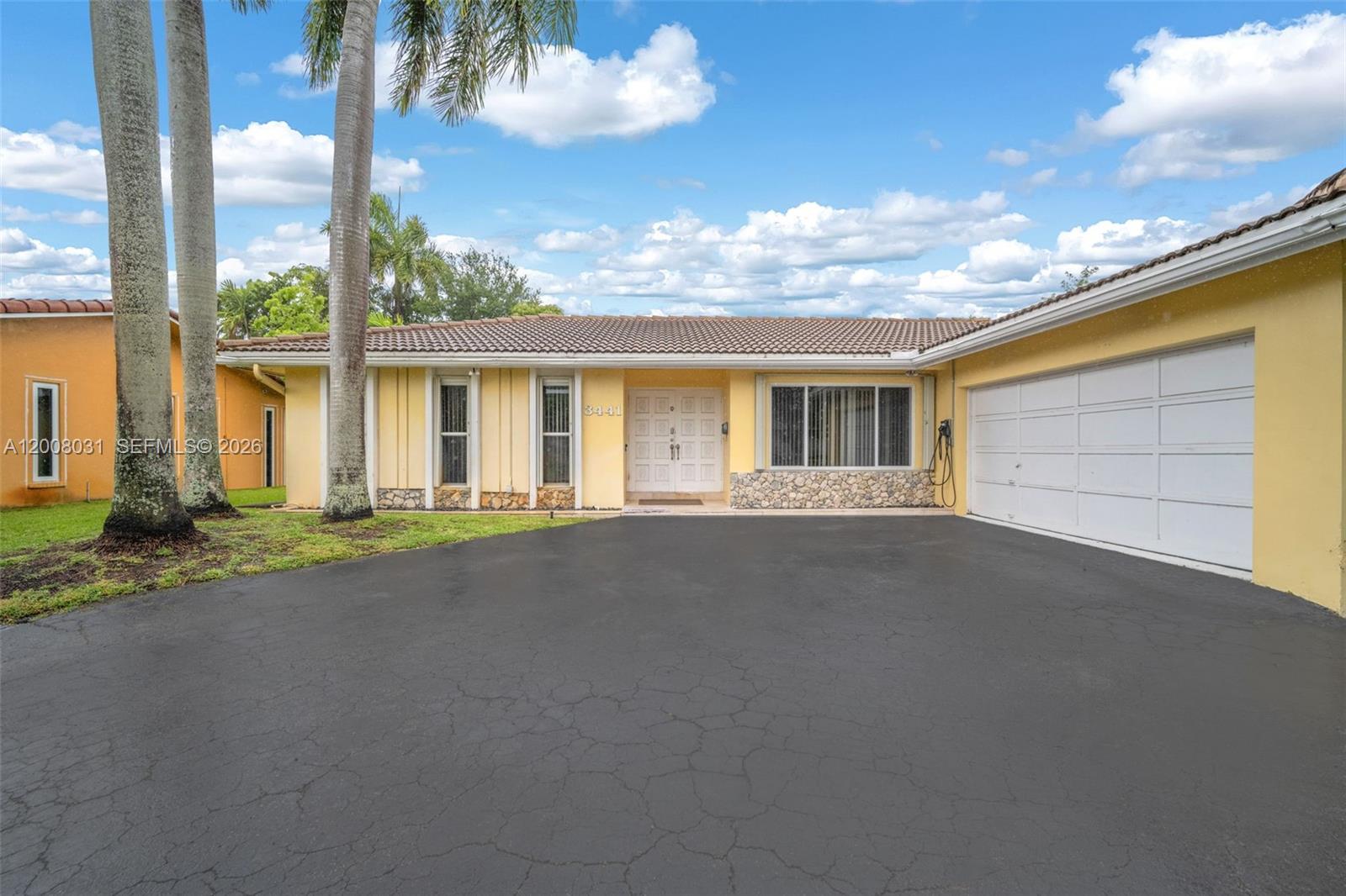 An open-concept living area features light-colored tile flooring, recessed lighting, and a modern kitchen — 3441 N Hills Dr # 00, Hollywood FL 33021, HOLLYWOOD, FL