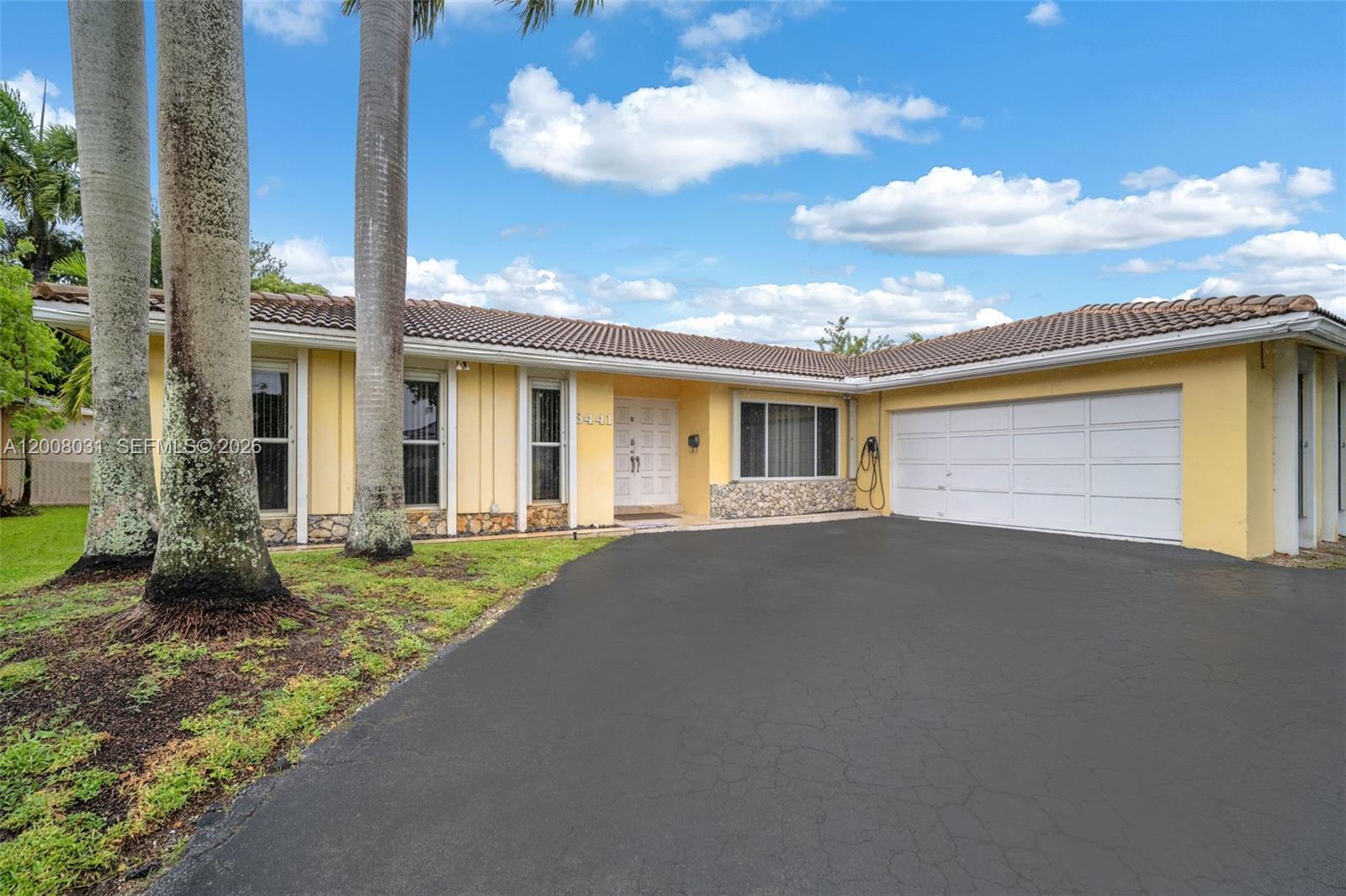 A bright, empty room features light-colored tile flooring, white walls, and a large window — 3441 N Hills Dr # 00, Hollywood FL 33021, HOLLYWOOD, FL