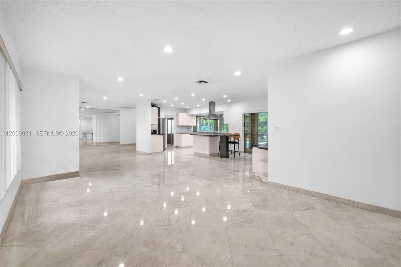 A bright, empty room features white walls, recessed lighting, and polished light-colored tile flooring — 3441 N Hills Dr # 00, Hollywood FL 33021, HOLLYWOOD, FL