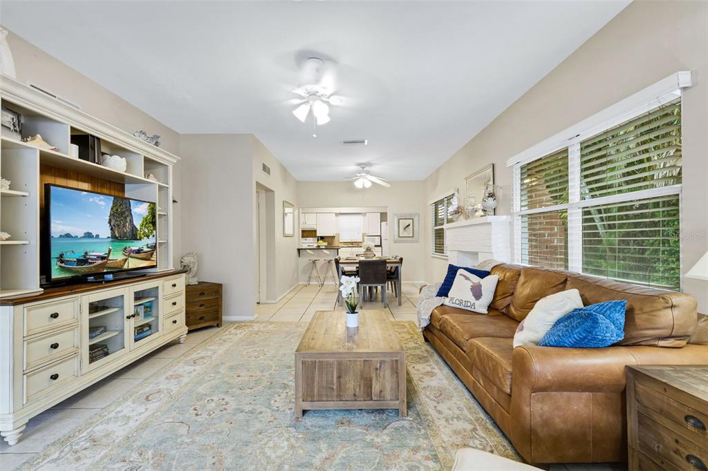 A living room with a leather sofa, wooden coffee table, and built-in media console — 18 HEILWOOD STREET, CLEARWATER, FL