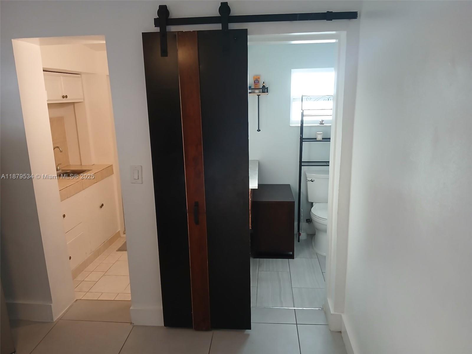 A bathroom with a sliding barn door, a vanity, and a toilet is visible — 11510 SW 182nd Ter # 2, Miami FL 33157, MIAMI, FL