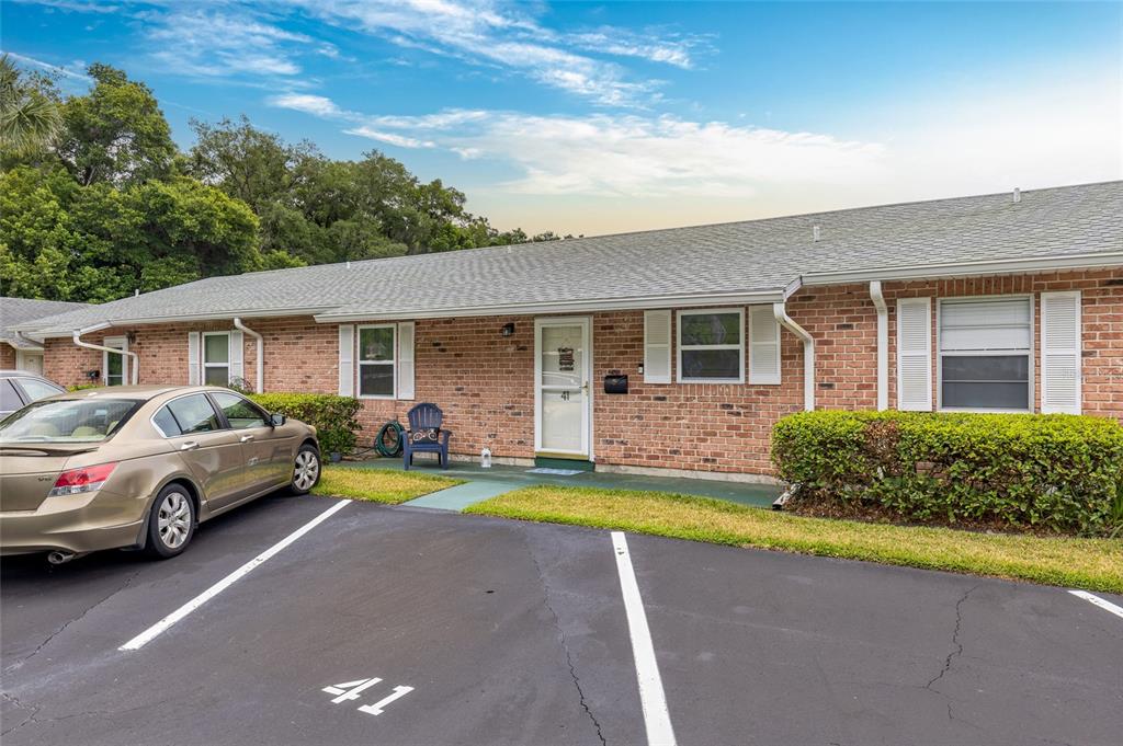 A single-story brick residential building with a parking space marked 41 in front — 41 FAIRWAY COURT UNIT 41, DELAND, FL