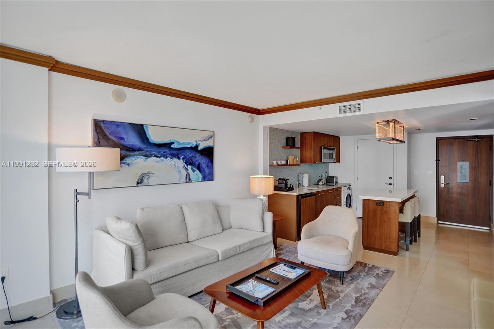A living room features a sofa, two armchairs, a coffee table, and a small kitchenette — 6801 Collins Ave # 314, Miami Beach FL 33141, MIAMI BEACH, FL