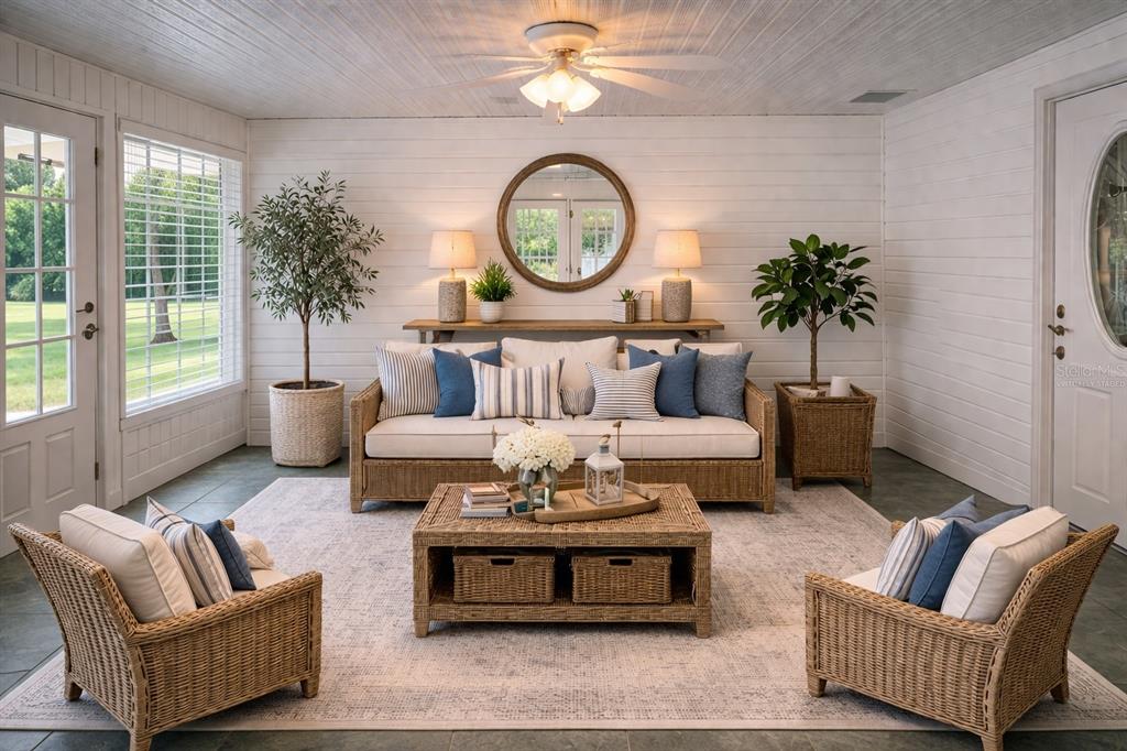 A sunroom features wicker furniture, a white shiplap wall, and a central ceiling fan — 7893 S US HIGHWAY 441, LAKE CITY, FL
