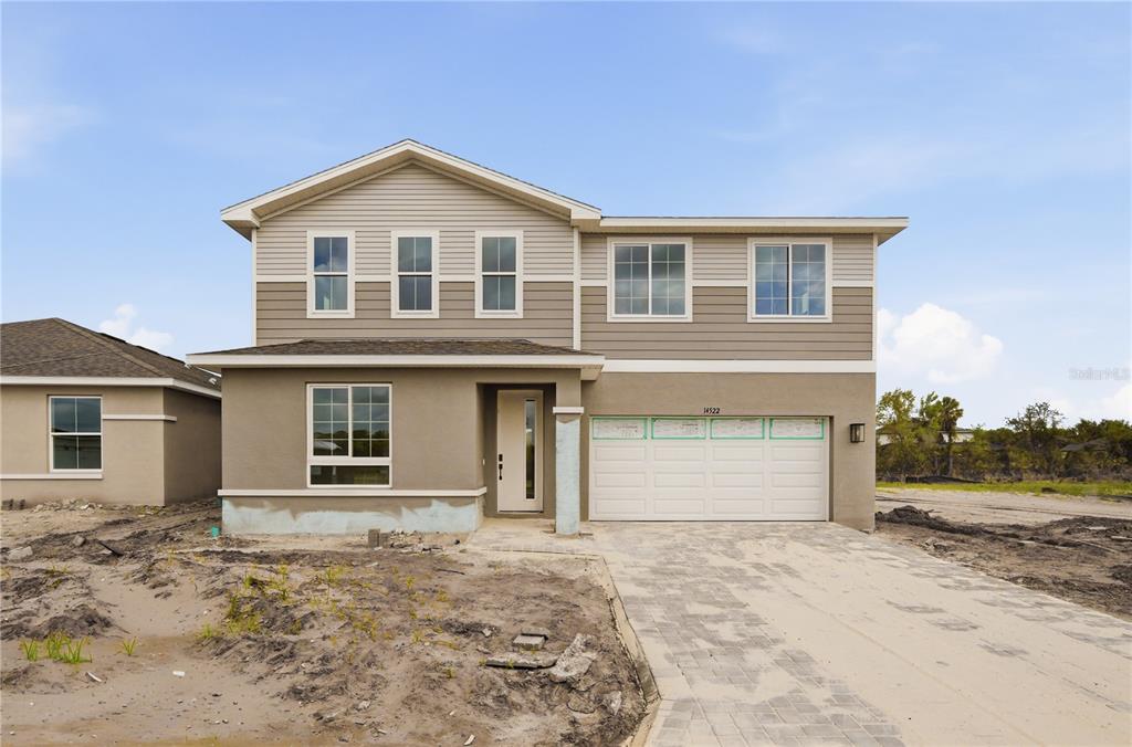 A two-story house with a beige stucco lower level and tan horizontal siding above — 14522 BANKS COURT, PARRISH, FL
