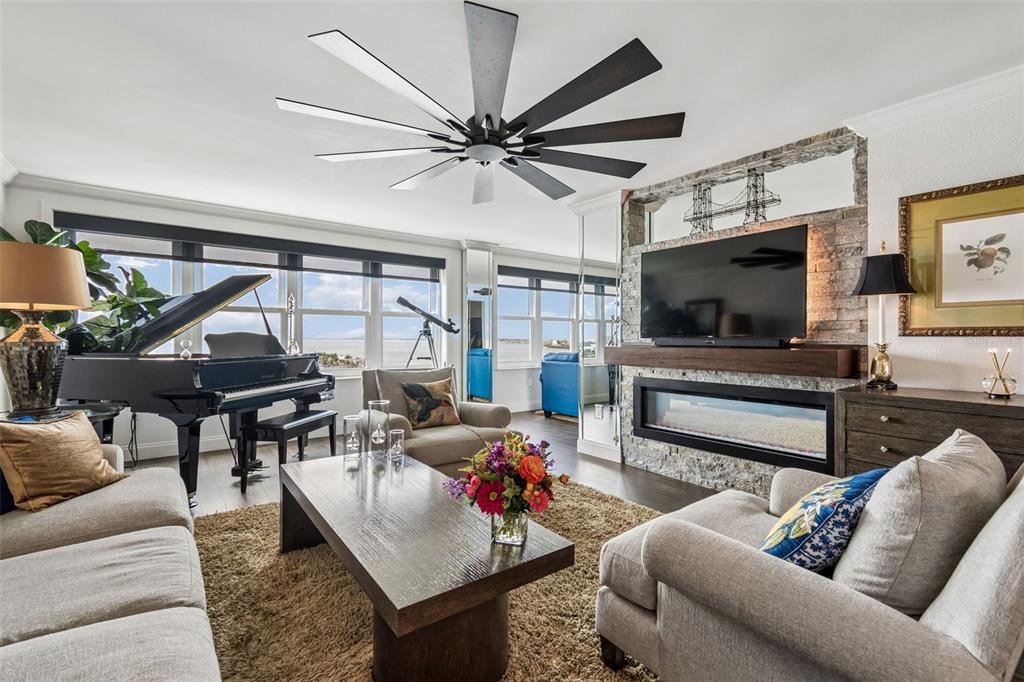 A kitchen features black cabinets, a gold farmhouse sink, and a mirrored subway tile backsplash — 5200 BRITTANY DRIVE S UNIT 1508, ST PETERSBURG, FL