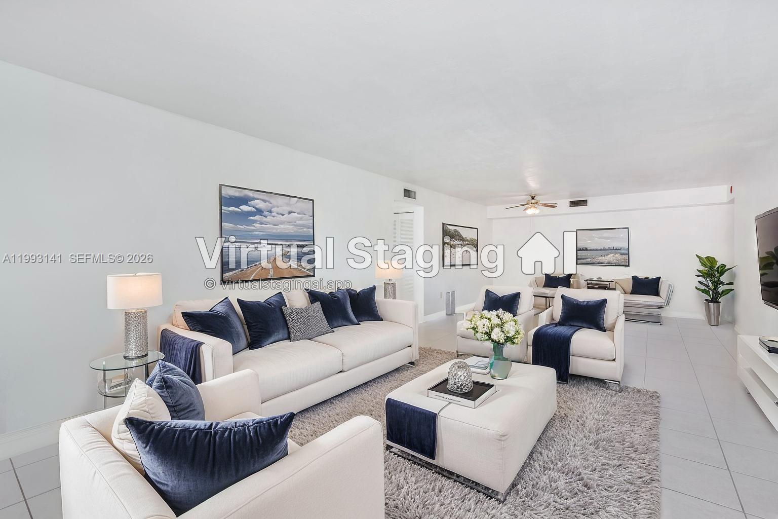 This is a virtually staged living room featuring white sofas, blue pillows, and tile flooring — 9423 SW 76th St # W21, Miami FL 33173, MIAMI, FL