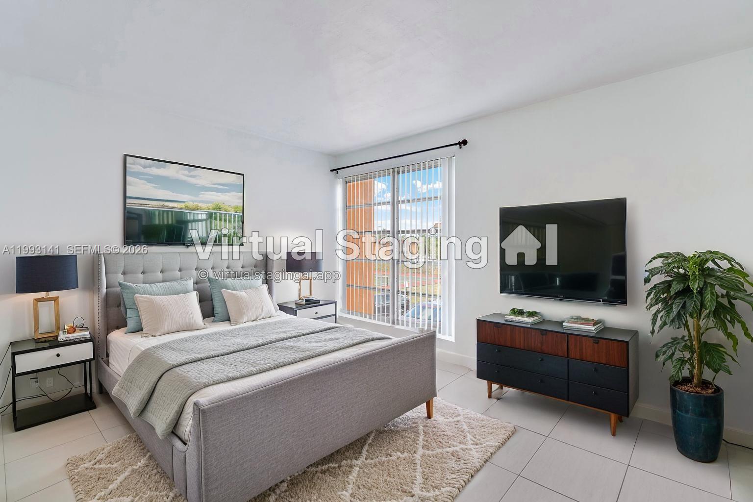 This is a virtually staged bedroom featuring a gray upholstered bed, dresser, and television — 9423 SW 76th St # W21, Miami FL 33173, MIAMI, FL