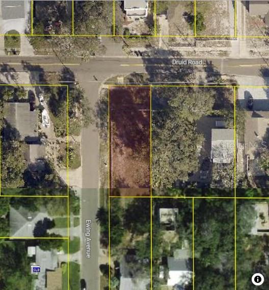 This is an aerial map view showing a vacant residential lot highlighted in brown — 1001 DRUID ROAD E, CLEARWATER, FL