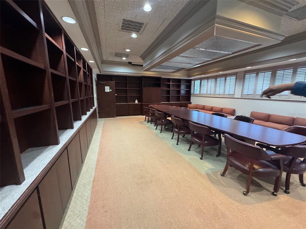 A conference room features a long table, rolling chairs, built-in bookshelves, and carpeted flooring — 3201 SW 34TH STREET FLOOR 2, OCALA, FL