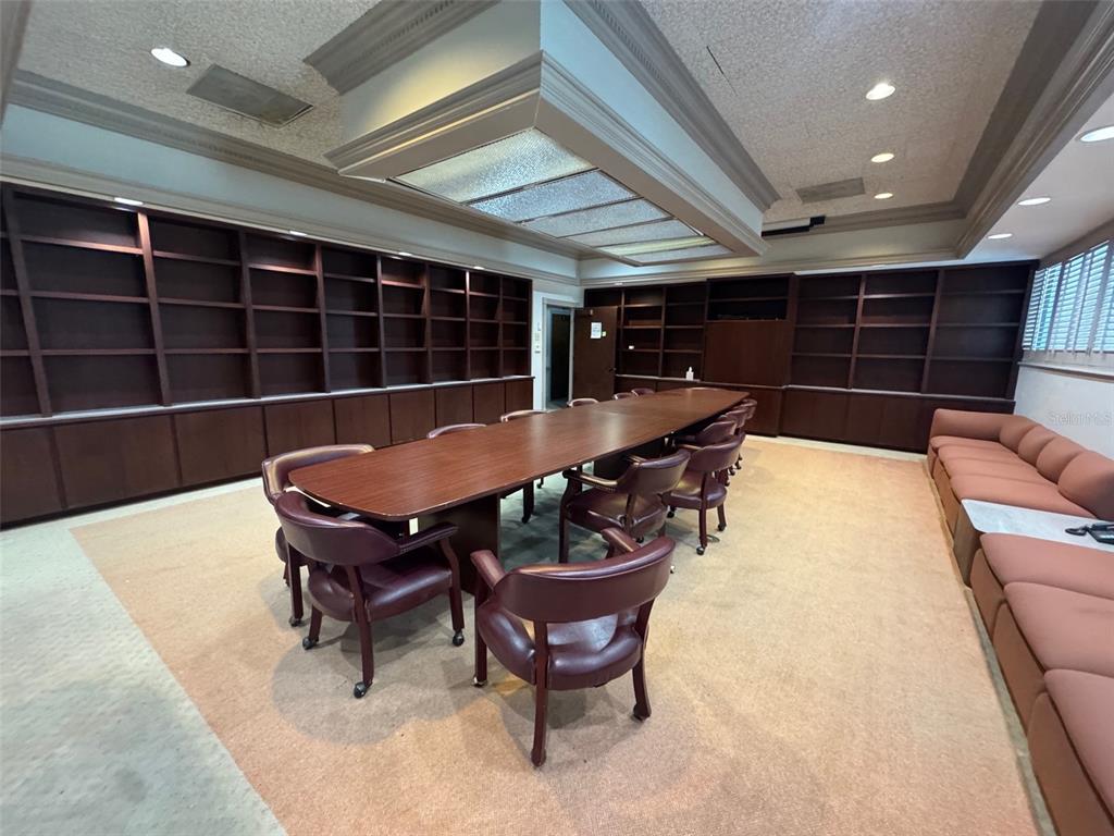 A conference room features a long wooden table, leather chairs, and extensive built-in wall shelving — 3201 SW 34TH STREET FLOOR 2, OCALA, FL