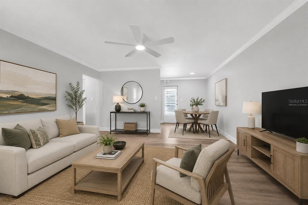 A living and dining area with light wood floors, neutral furniture, and a ceiling fan — 151 NORTH ORLANDO AVENUE UNIT 142, WINTER PARK, FL
